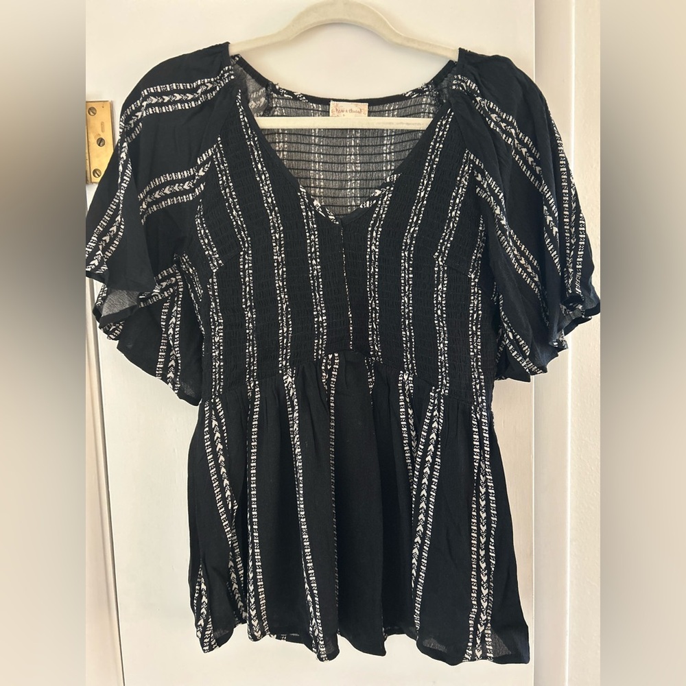 Hem and Thread V Neck Peplum Top large